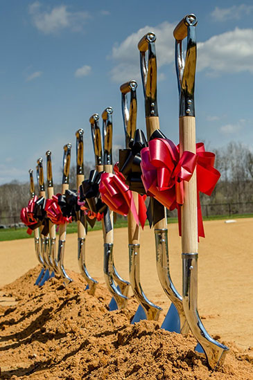 Groundbreaking shovels lined up in sand at Creekview Park.